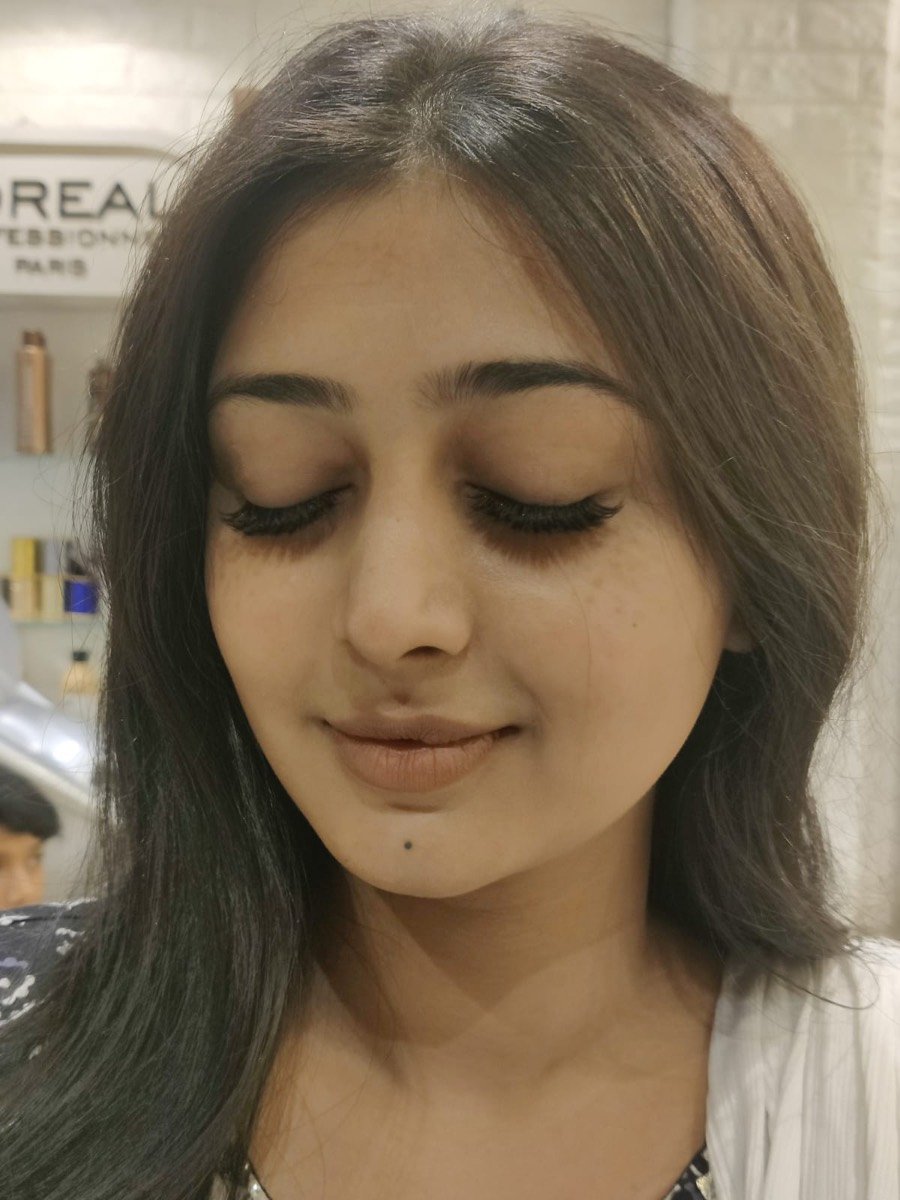 Client with classic eyelash extensions, eyes closed